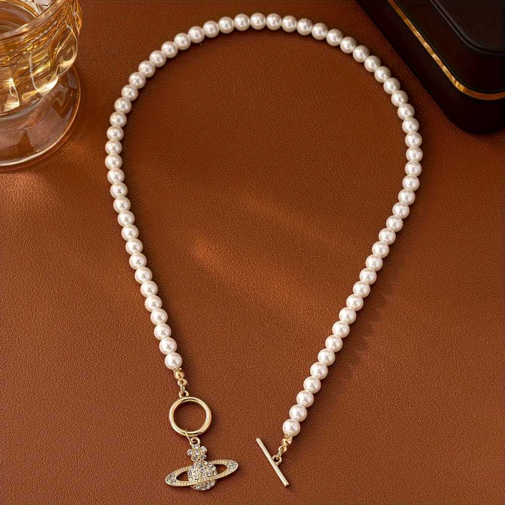 Elegant Faux Pearl Necklace with Flower and Rhinestone Planet Pendant.